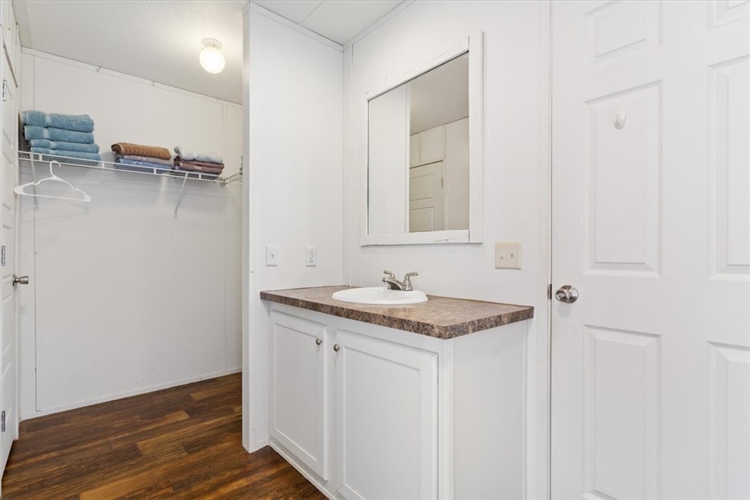 6067 Old Mexia Road Waco, TX 76705 - Photo 23 of 32 a bathroom with a granite countertop sink and a mirror