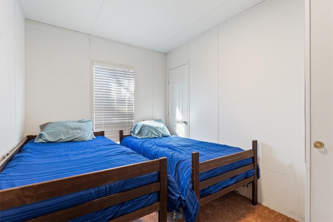6067 Old Mexia Road Waco, TX 76705 - Photo 24 of 32 a bedroom with two beds and a desk