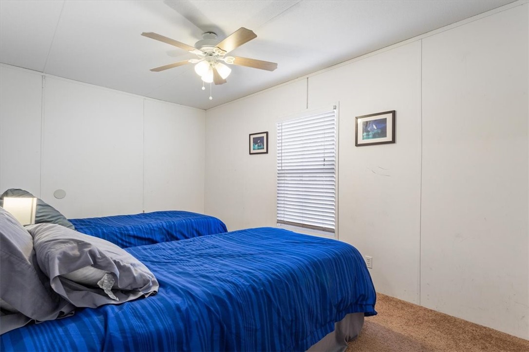 6067 Old Mexia Road Waco, TX 76705 - Photo 25 of 32 a bedroom with a bed and a ceiling fan