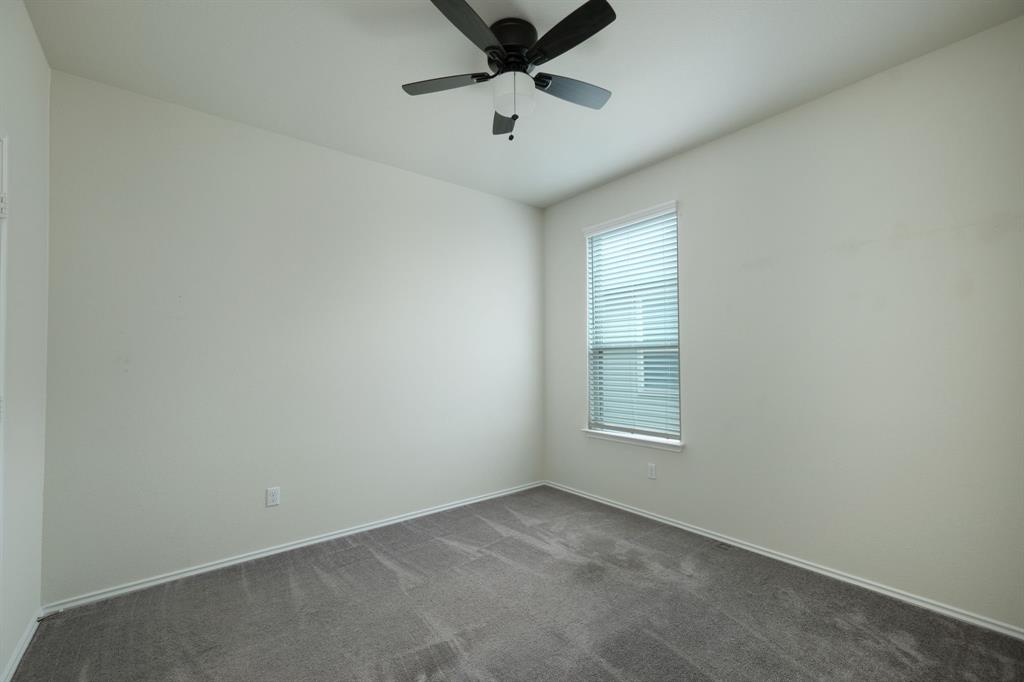 1409 Cliffbrake Way Georgetown, TX 78626 - Photo 6 of 10 Neutral-toned room featuring a single window with blinds, a ceiling fan, light gray carpeting, and white baseboards