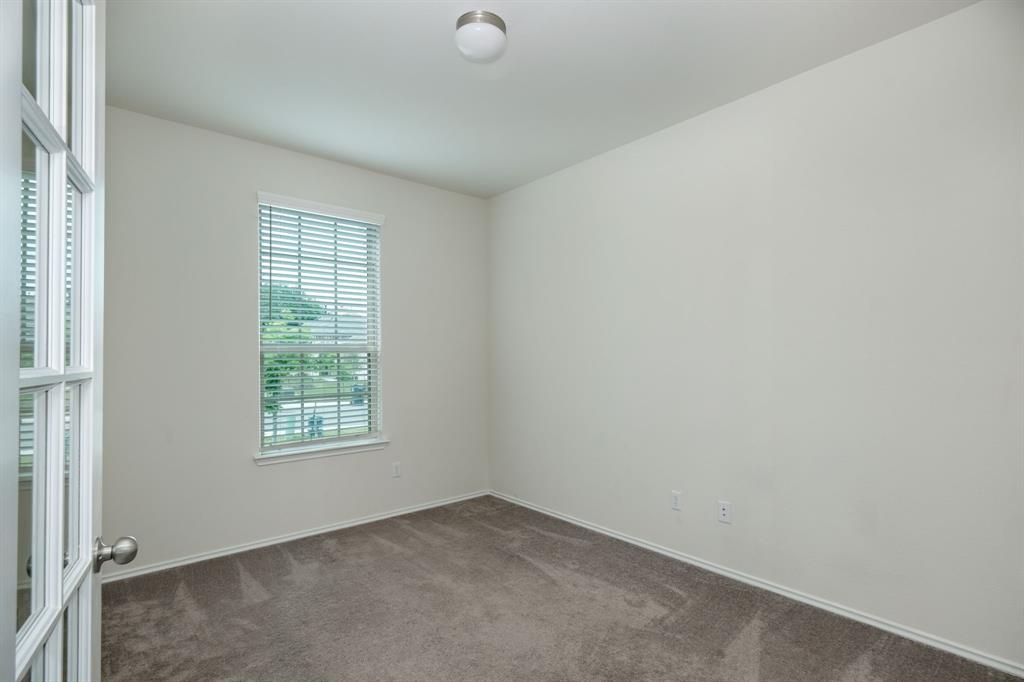 1409 Cliffbrake Way Georgetown, TX 78626 - Photo 7 of 10 Room with neutral-toned carpeting, a window featuring horizontal blinds, and a white ceiling with a flush-mount light fixture