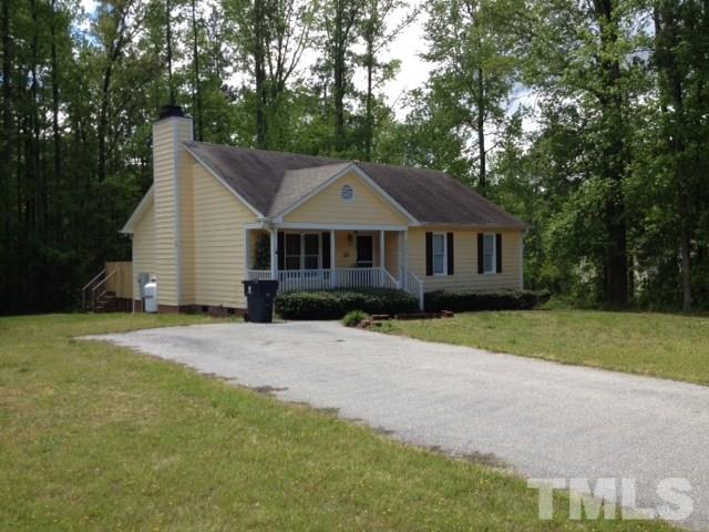 4300 Rockside Hills Drive Raleigh, NC 27603 - Photo 1 of 11 a front view of a house with a yard and garage