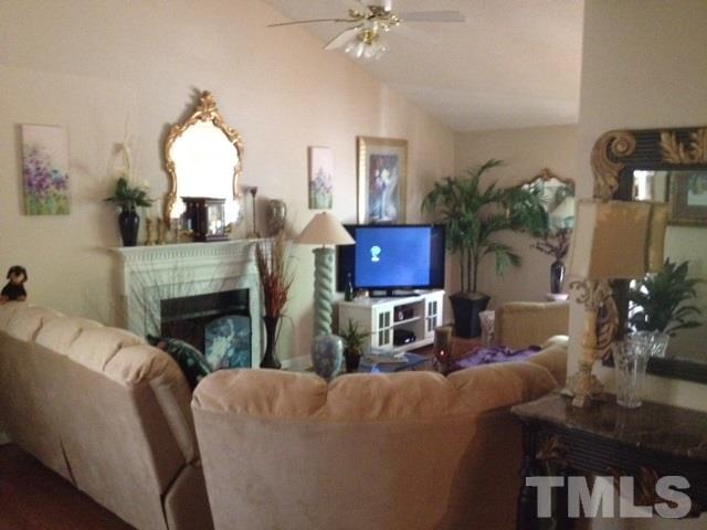 4300 Rockside Hills Drive Raleigh, NC 27603 - Photo 6 of 11 a living room with furniture a fireplace and a potted plant
