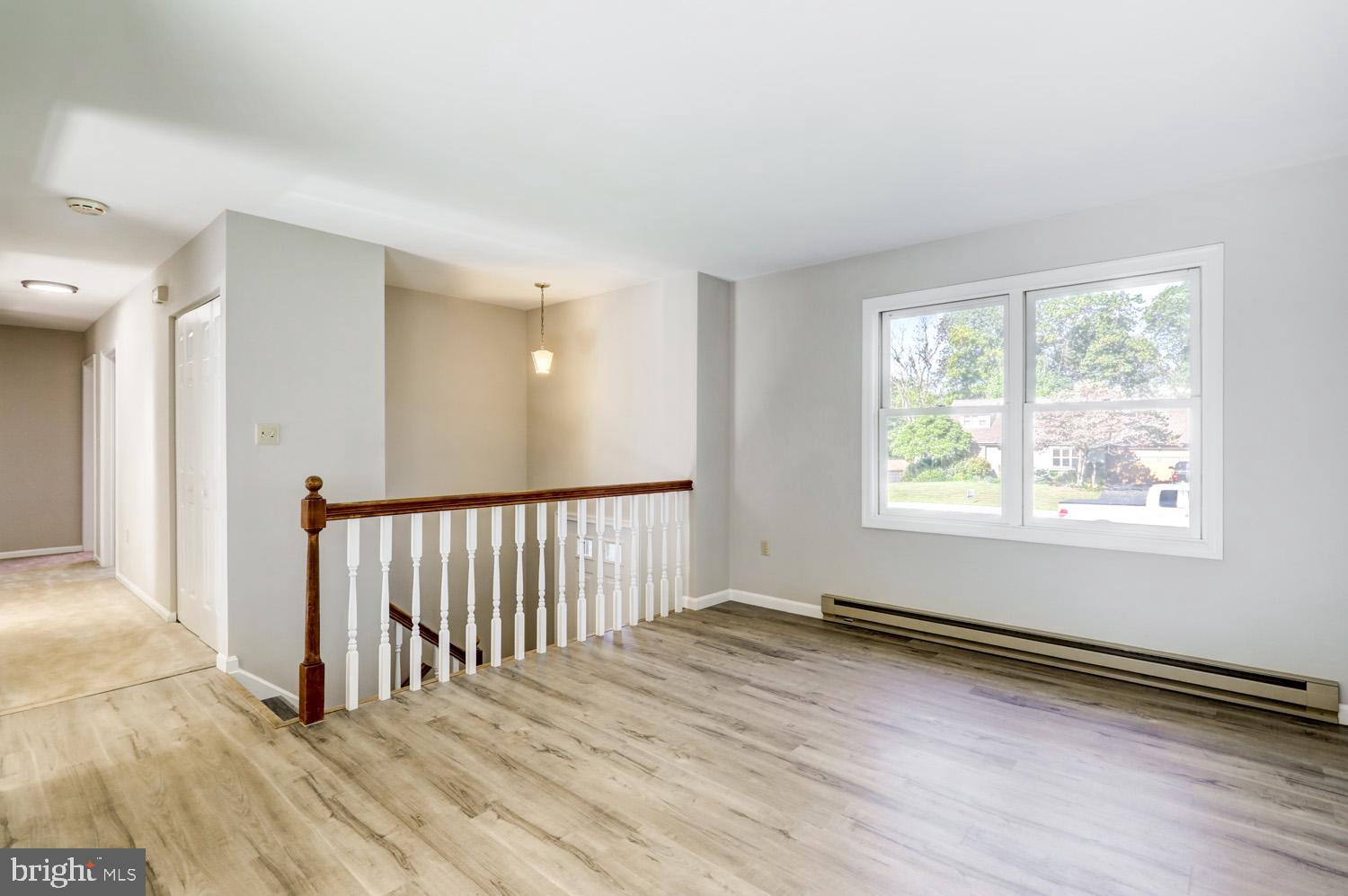 230 Hickory Drive Lititz, PA 17543 - Photo 17 of 43 an empty room with wooden floor and windows