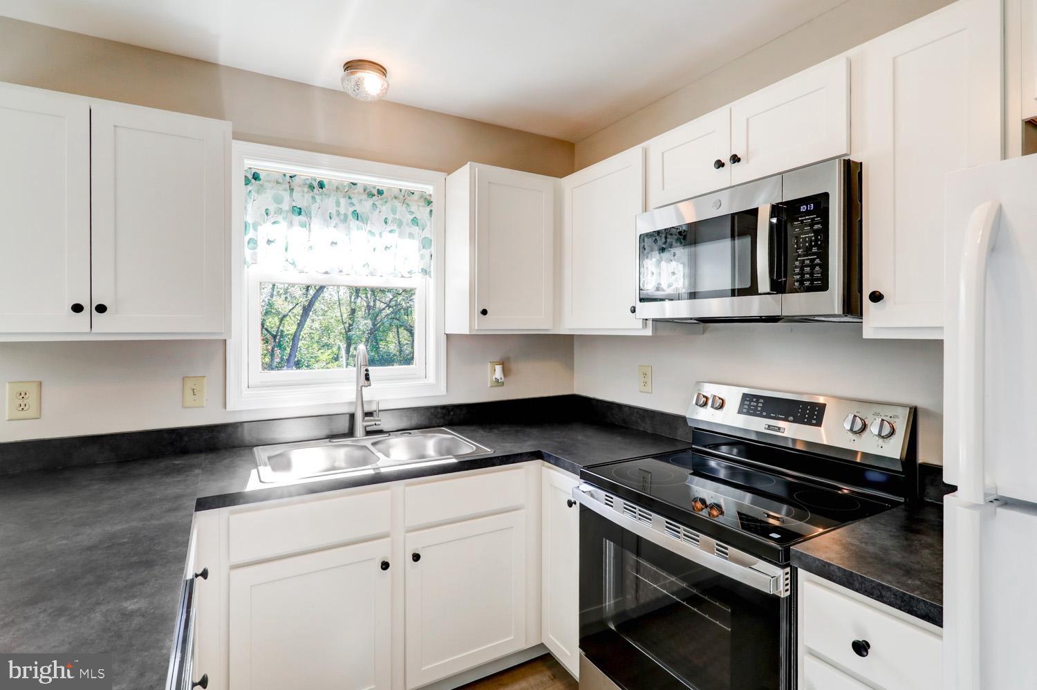 230 Hickory Drive Lititz, PA 17543 - Photo 25 of 43 a kitchen with granite countertop a stove sink and microwave