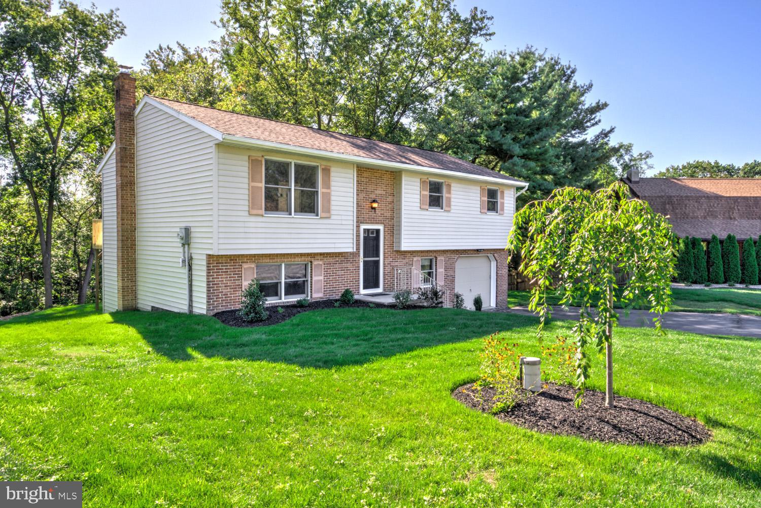 230 Hickory Drive Lititz, PA 17543 - Photo 4 of 43 a front view of house with a garden and patio