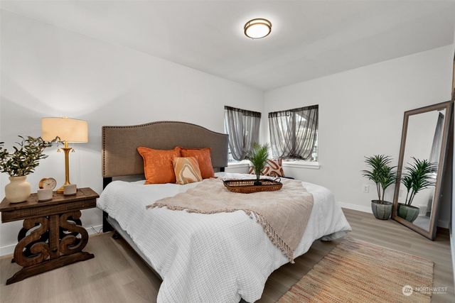 a bedroom with bed and a potted plant