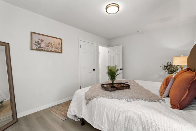 a bedroom with a bed and a potted plant
