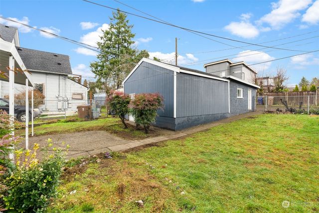 a view of a house with brick walls and a yard