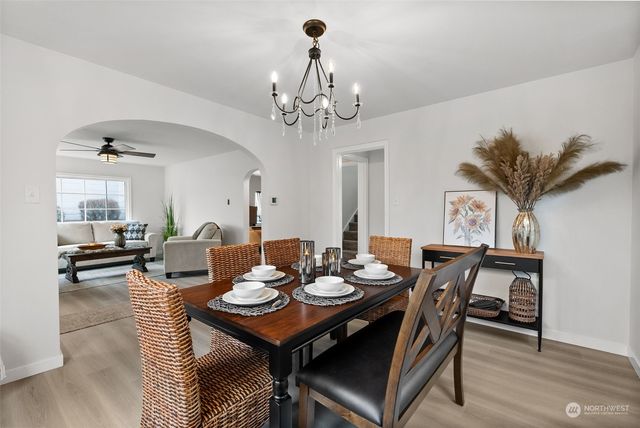 a view of a dining room with furniture and chandelier