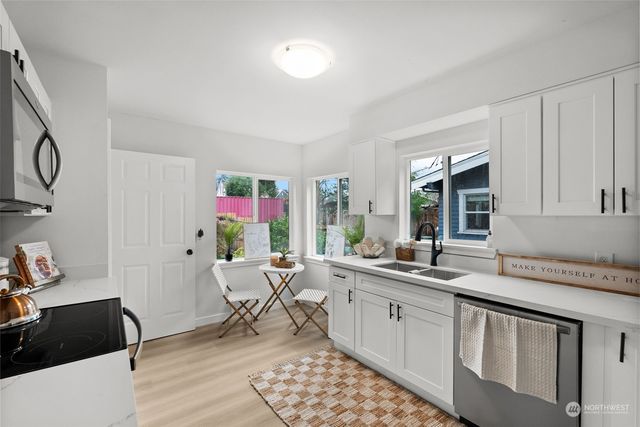 a kitchen with a sink cabinets and window