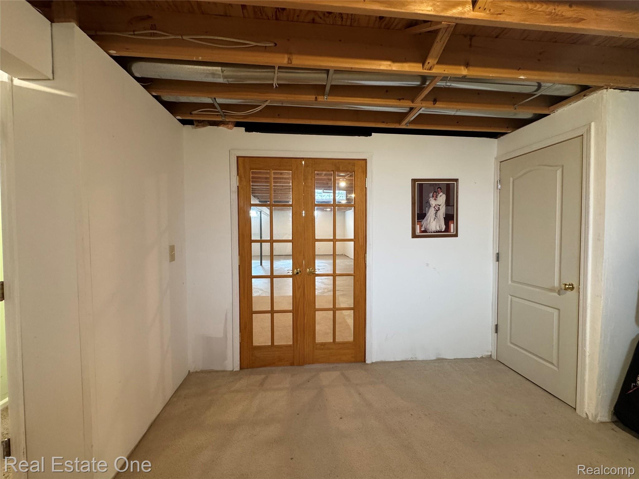1668 South Shore Drive Rochester, MI 48307 - Photo 25 of 27 Basement featuring light carpet and french doors