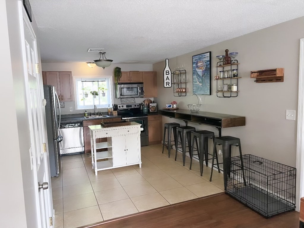 5455 North Main Street, Unit 20F Fall River, MA 02720 - Photo 3 of 9 a kitchen with a cabinets and chairs