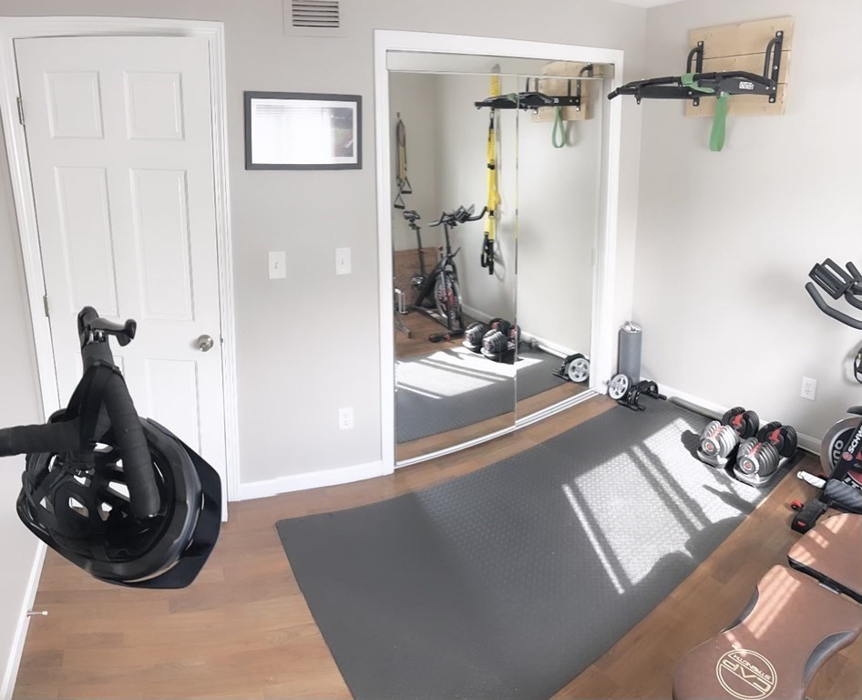 5455 North Main Street, Unit 20F Fall River, MA 02720 - Photo 7 of 9 a room with a wooden floor and gym equipment