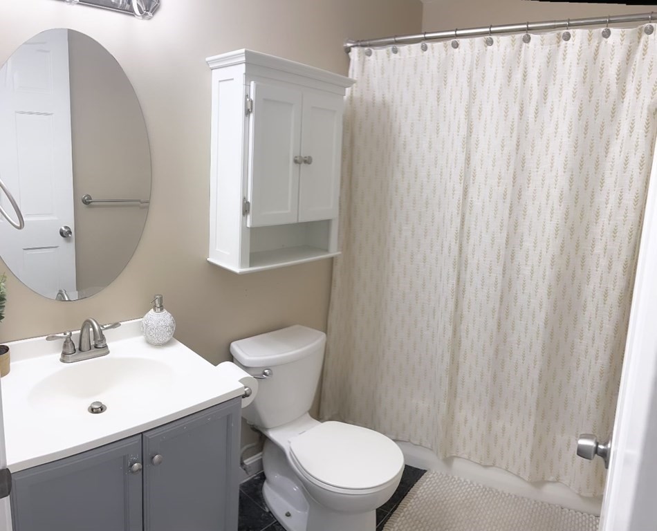 5455 North Main Street, Unit 20F Fall River, MA 02720 - Photo 8 of 9 a bathroom with a toilet a sink and a mirror
