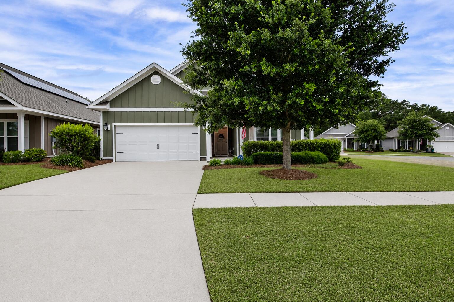 131 Dusky Way Freeport, FL 32439 - Photo 2 of 39 a view of a house with a yard and potted plants