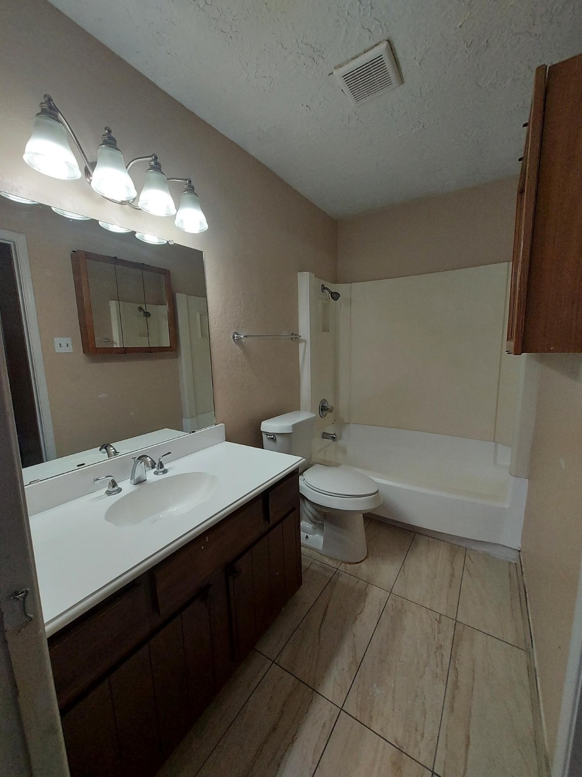 13433 Castilian Drive, Unit 1 Houston, TX 77015 - Photo 9 of 10 a bathroom with a sink a toilet and mirror
