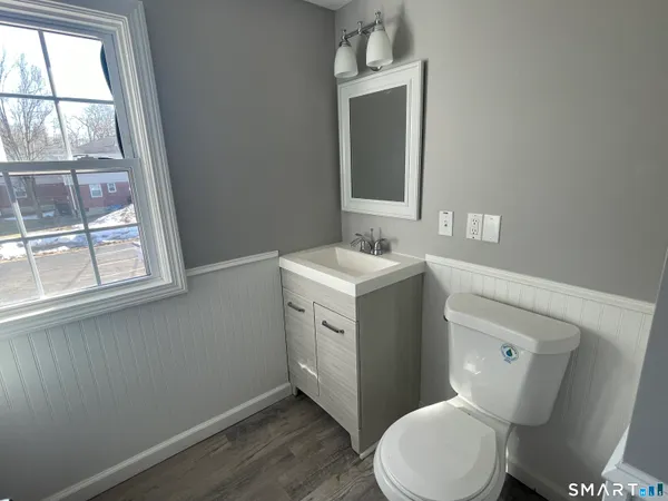 a white toilet sitting next to a bathroom sink