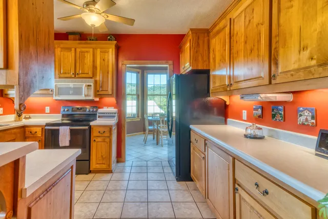 a kitchen with stainless steel appliances granite countertop a sink and a refrigerator
