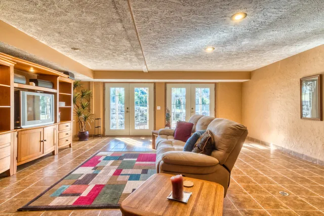 a living room with furniture and a floor to ceiling window