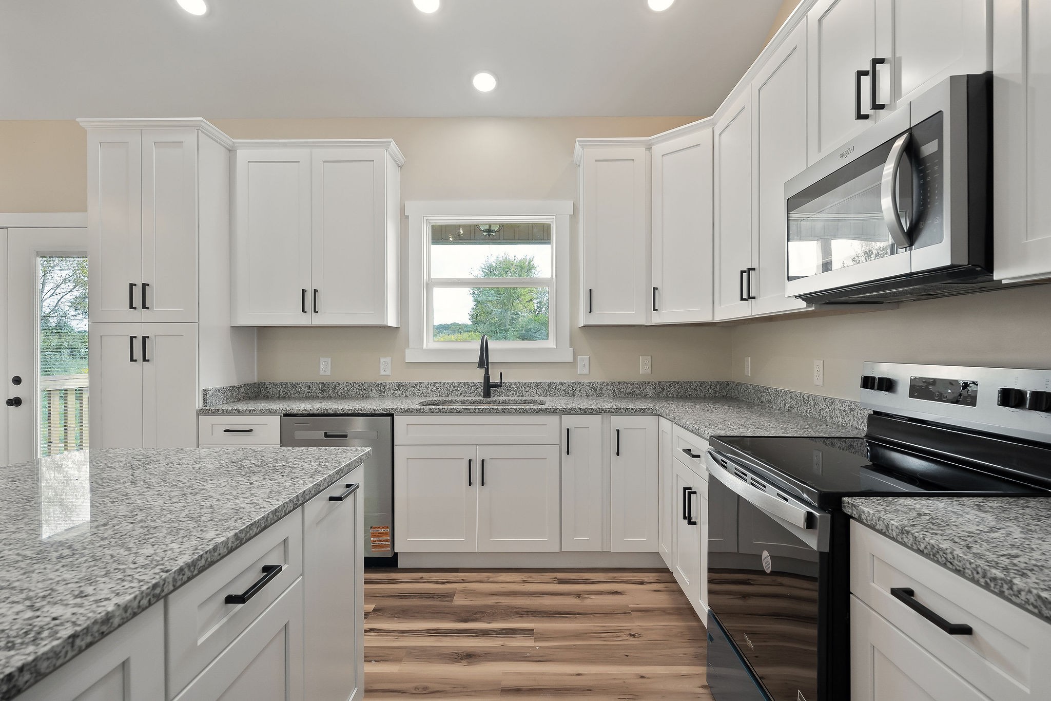 6544 Thomas Twin Oaks Road Baxter, TN 38544 - Photo 11 of 32 a kitchen with stainless steel appliances granite countertop a sink and a stove