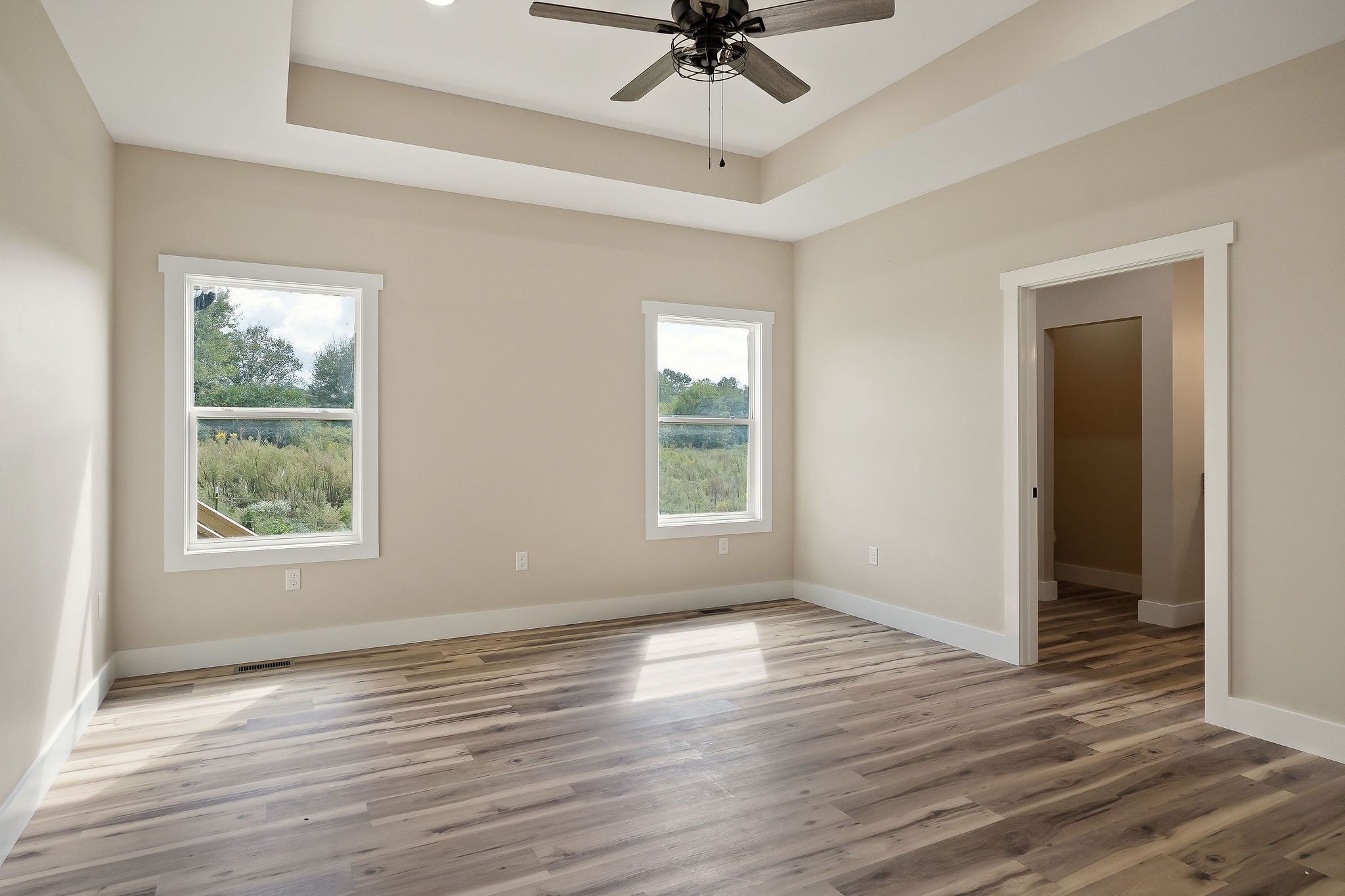 6544 Thomas Twin Oaks Road Baxter, TN 38544 - Photo 12 of 32 an empty room with wooden floor fan and windows