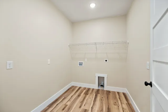 a view of a room with wooden floor