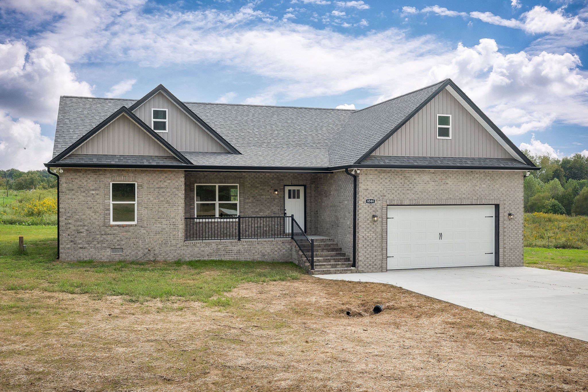6544 Thomas Twin Oaks Road Baxter, TN 38544 - Photo 26 of 32 a front view of a house with a yard and garage
