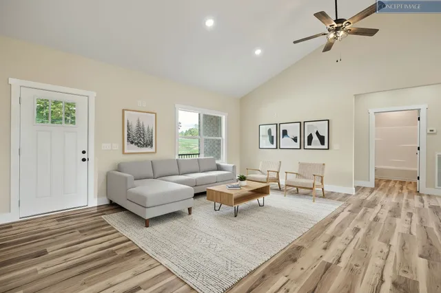 a living room with furniture and a wooden floor