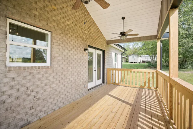 a view of a balcony with wooden floor