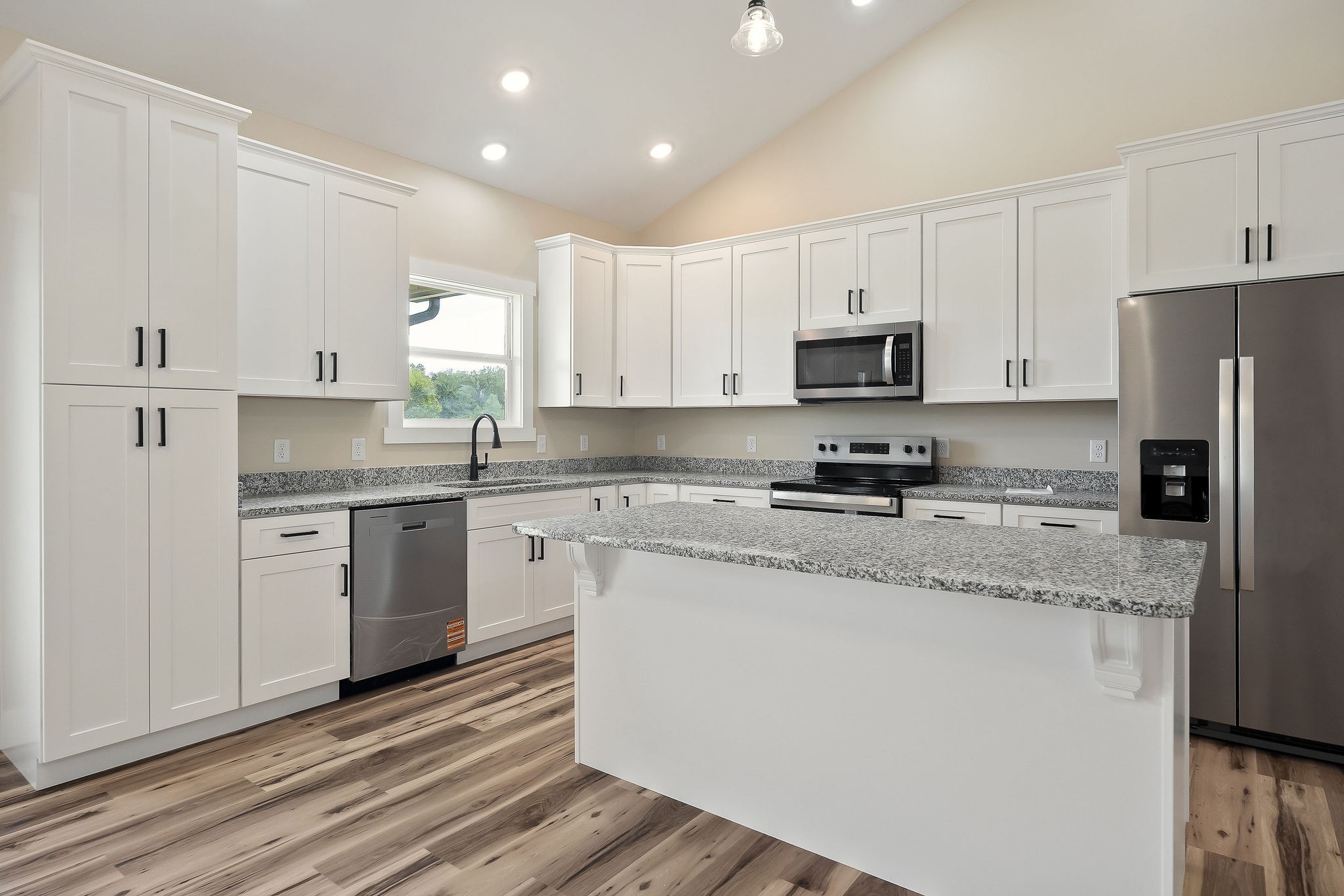 6544 Thomas Twin Oaks Road Baxter, TN 38544 - Photo 8 of 32 a kitchen with granite countertop white cabinets and stainless steel appliances