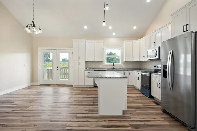 a kitchen with a refrigerator sink and cabinets