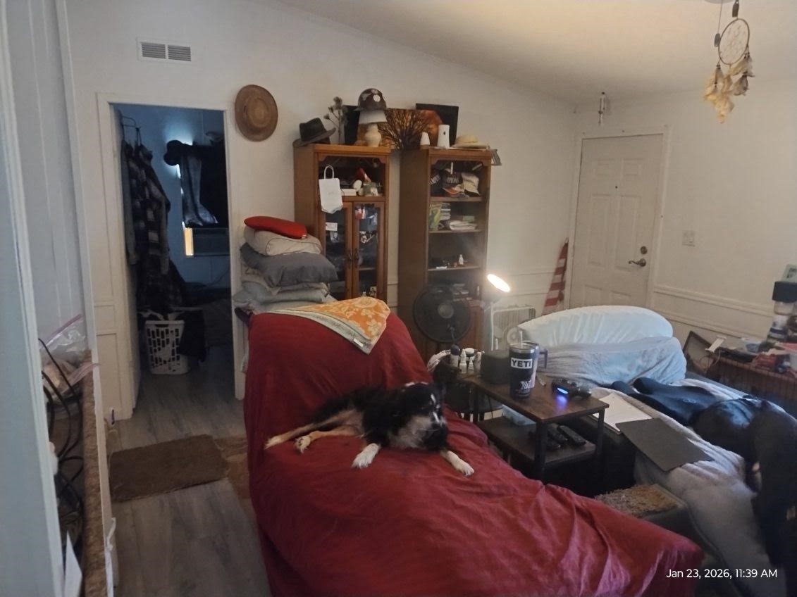 180 Woods Road Coldspring, TX 77331 - Photo 11 of 35 a bed room with a bed and two mirror