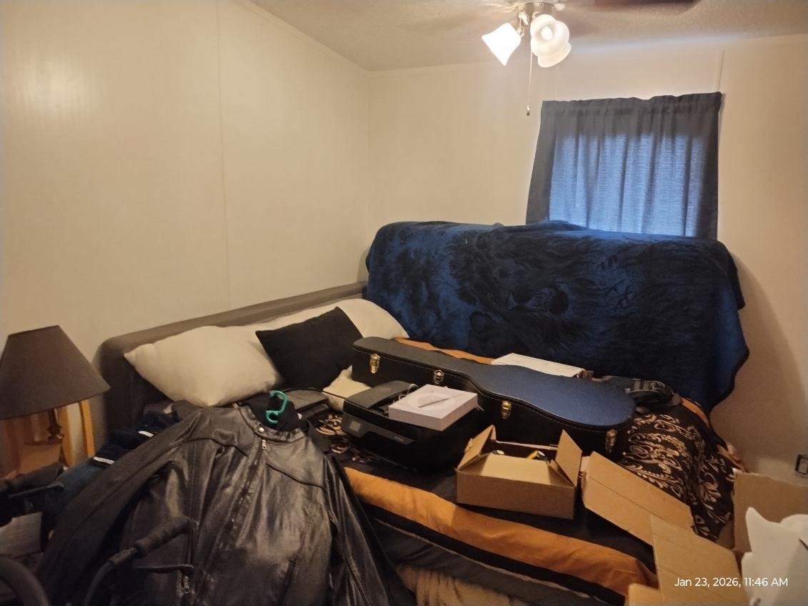 180 Woods Road Coldspring, TX 77331 - Photo 12 of 35 a bedroom with a bed and dresser