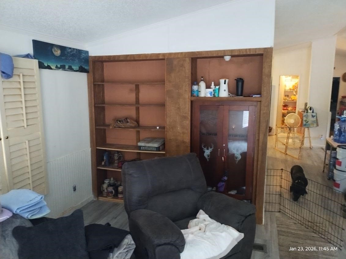 180 Woods Road Coldspring, TX 77331 - Photo 14 of 35 a living room with furniture and a fireplace