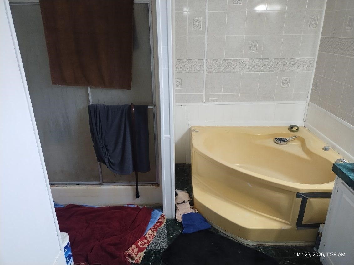 180 Woods Road Coldspring, TX 77331 - Photo 19 of 35 a bathroom with a bathtub and a shower