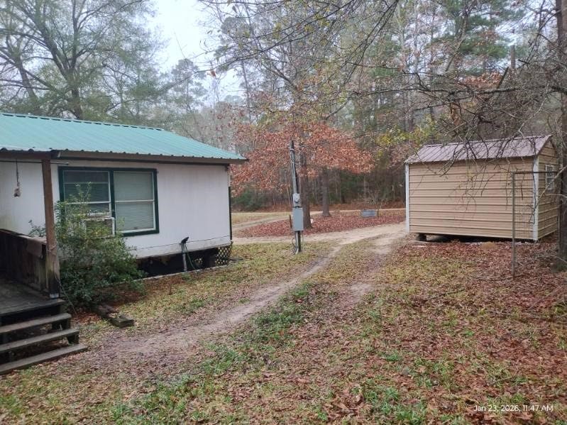 180 Woods Road Coldspring, TX 77331 - Photo 24 of 35 a backyard of a house with lots of green space