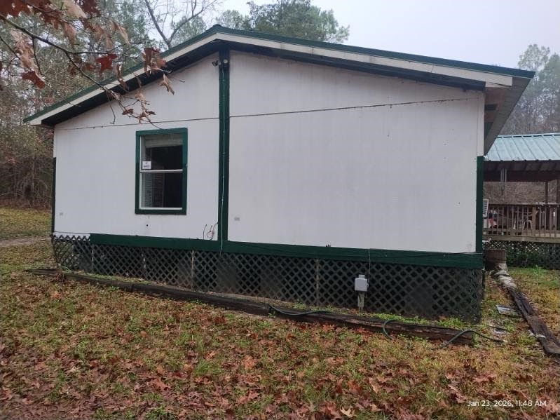 180 Woods Road Coldspring, TX 77331 - Photo 25 of 35 a front view of a house with a yard