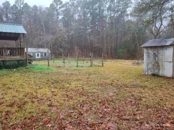 180 Woods Road Coldspring, TX 77331 - Photo 27 of 35 a backyard of a house with lots of green space