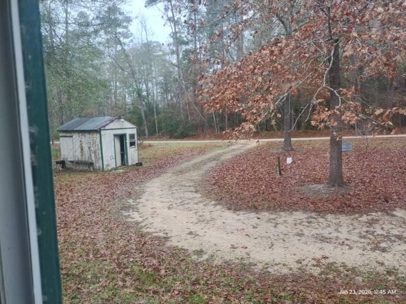 180 Woods Road Coldspring, TX 77331 - Photo 28 of 35 a backyard of a house with barbeque oven