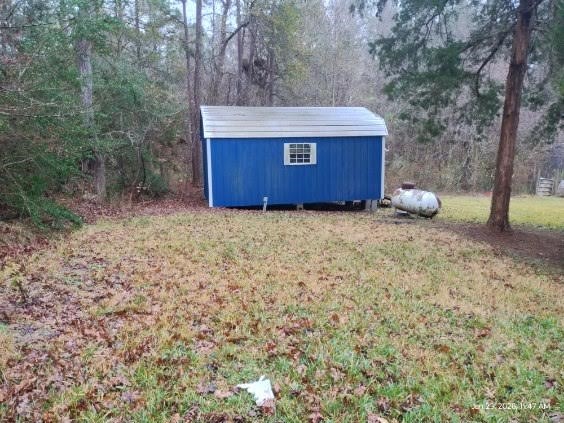 180 Woods Road Coldspring, TX 77331 - Photo 33 of 35 a view of a house with a yard