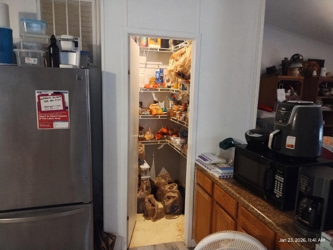 180 Woods Road Coldspring, TX 77331 - Photo 5 of 35 a kitchen with a refrigerator and a stove