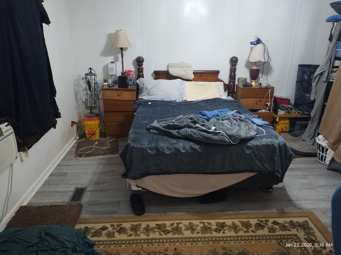 180 Woods Road Coldspring, TX 77331 - Photo 10 of 35 a bed sitting in a bedroom next to a window