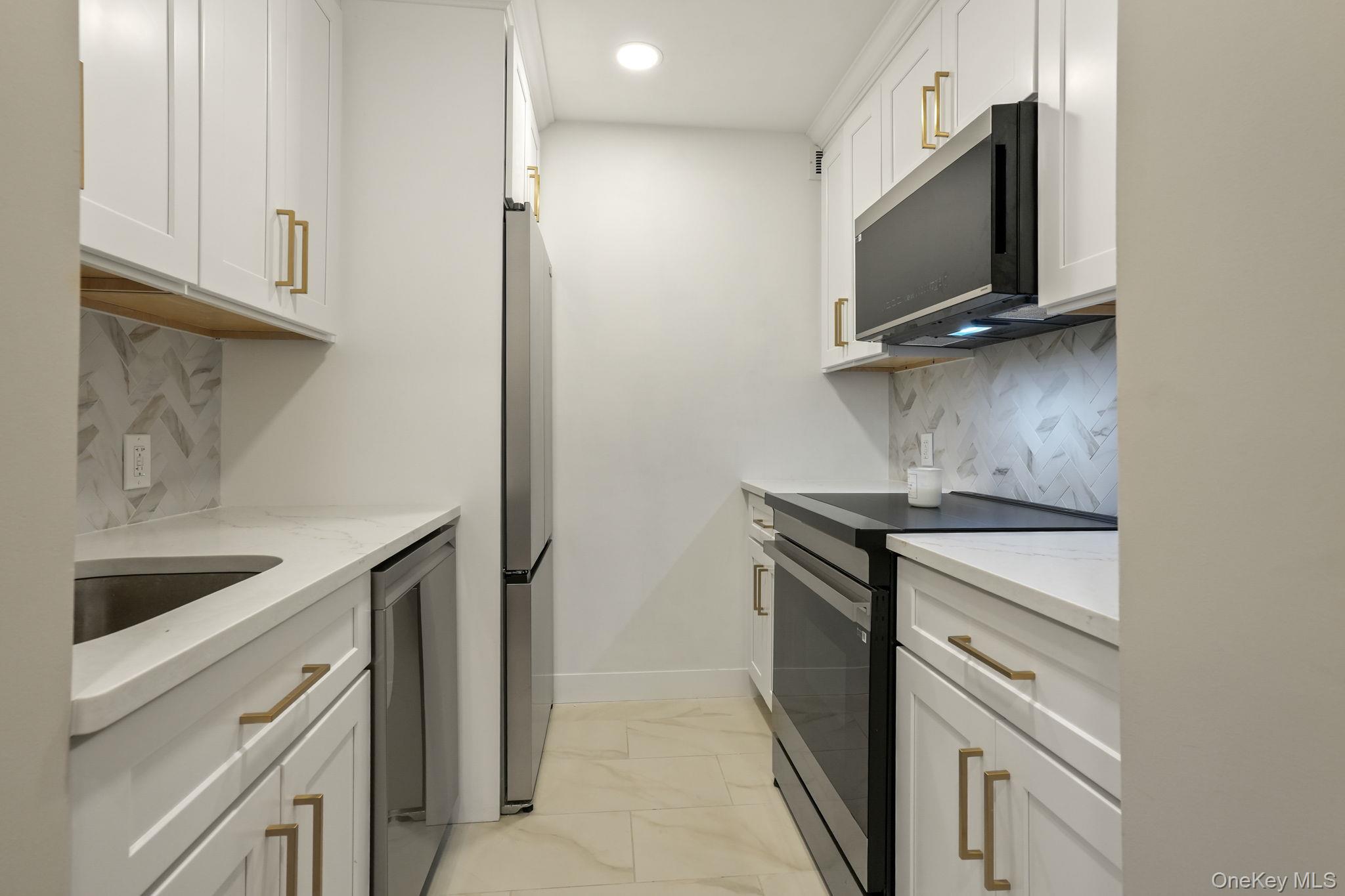 5108 Villa At The Peekskill, NY 10566 - Photo 2 of 26 a kitchen with a stove and a microwave