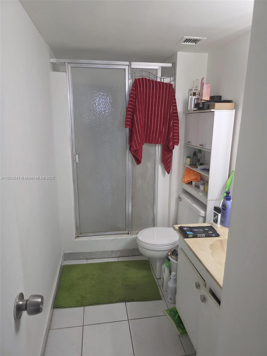 13499 Biscayne Boulevard, Unit 1005 North Miami, FL 33181 - Photo 11 of 15 a bathroom with a toilet and a shower