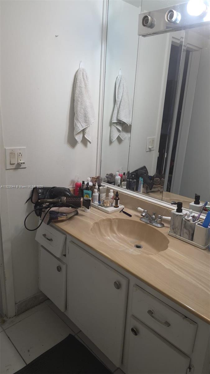 13499 Biscayne Boulevard, Unit 1005 North Miami, FL 33181 - Photo 6 of 15 a bathroom with a double vanity sink and a mirror