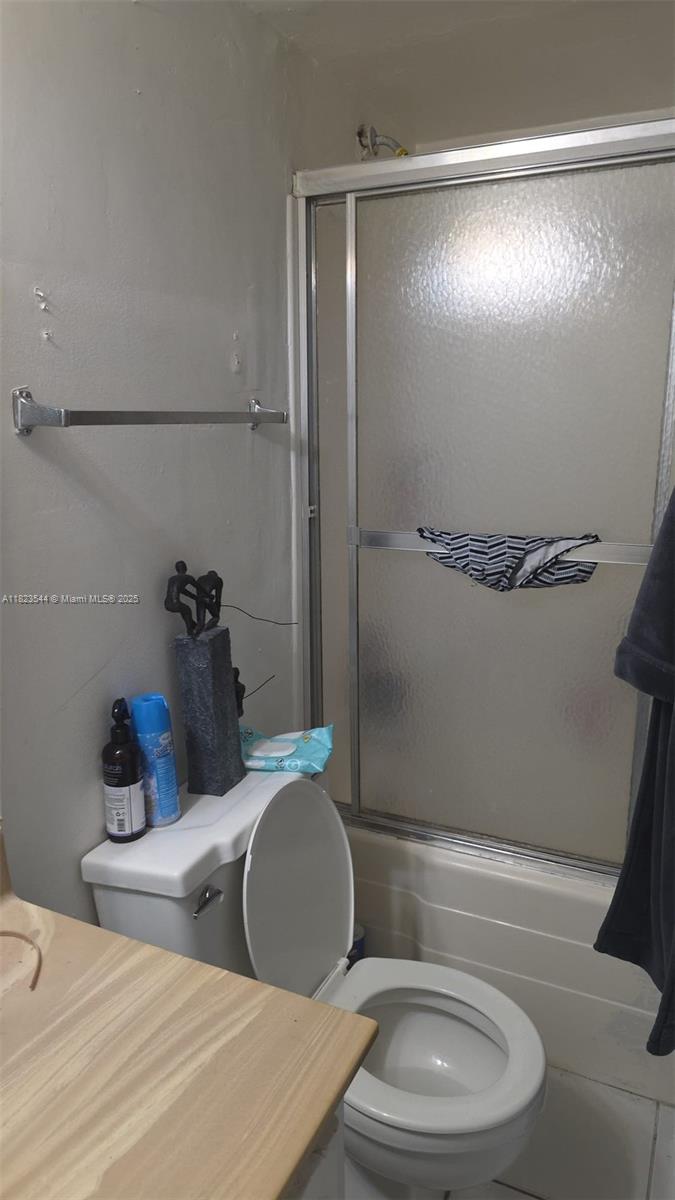 13499 Biscayne Boulevard, Unit 1005 North Miami, FL 33181 - Photo 7 of 15 a bathroom with a granite countertop bathtub sink vanity mirror and toilet