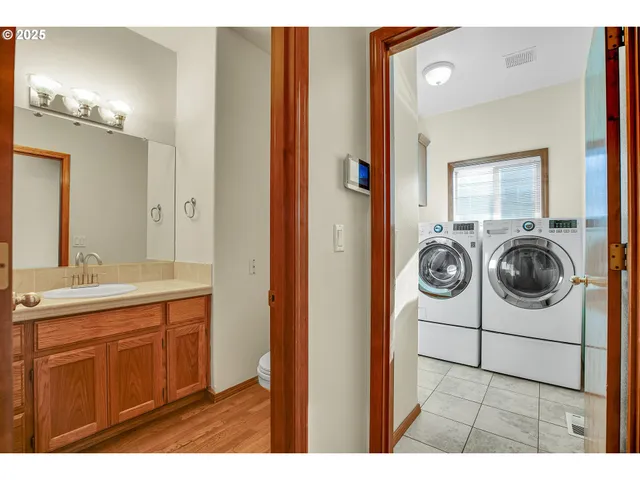 a bathroom with a granite countertop toilet sink and mirror