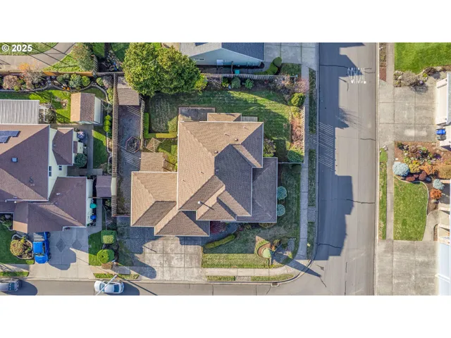 an aerial view of residential houses with outdoor space and swimming pool