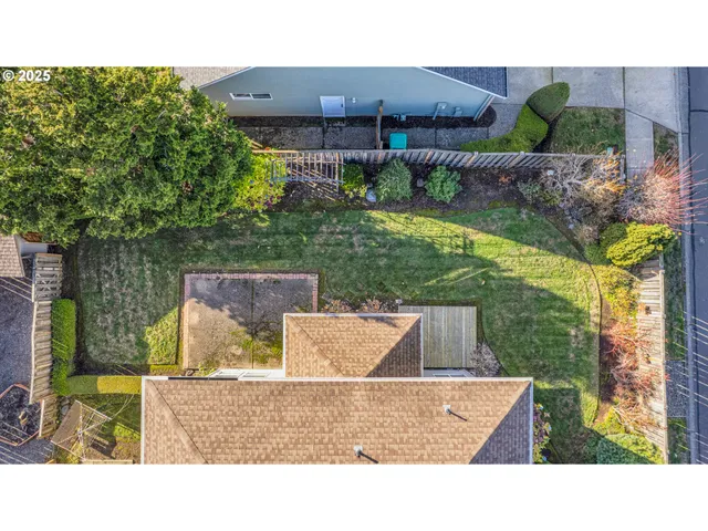 an aerial view of residential houses with outdoor space and ocean view